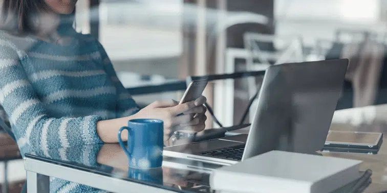 WOman with phone and laptop