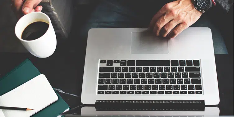 Man working on laptop using marketing automation