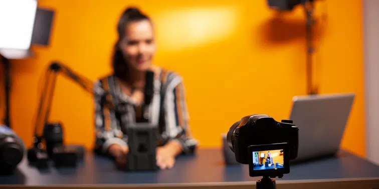 Woman recording video with camera